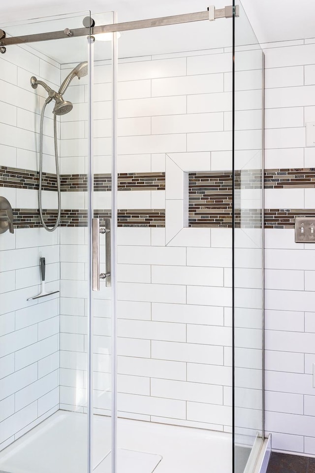 full bath featuring a shower stall