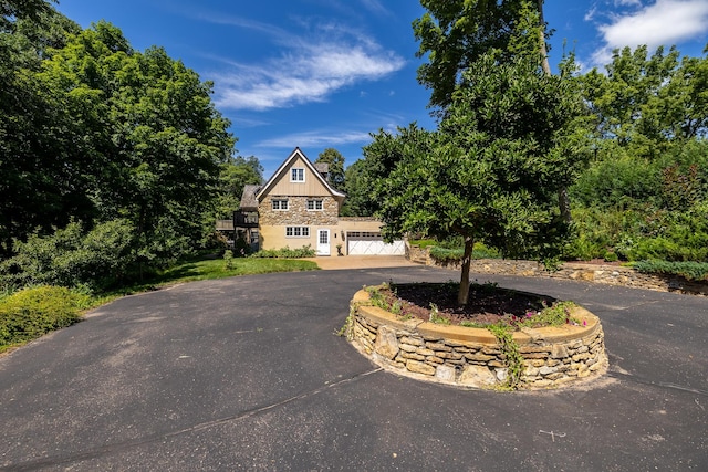 view of front of home featuring curved driveway and an attached garage