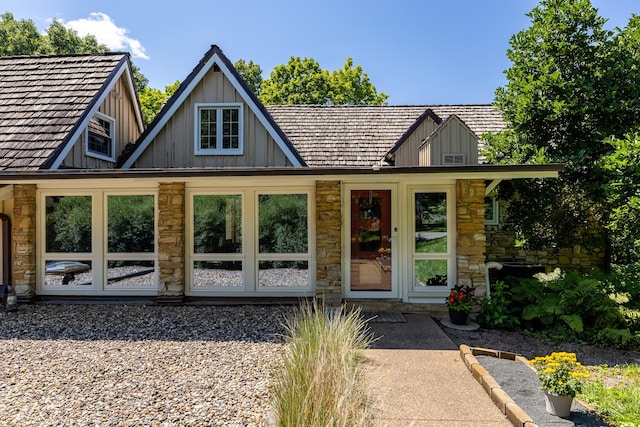 view of front facade featuring stone siding and board and batten siding