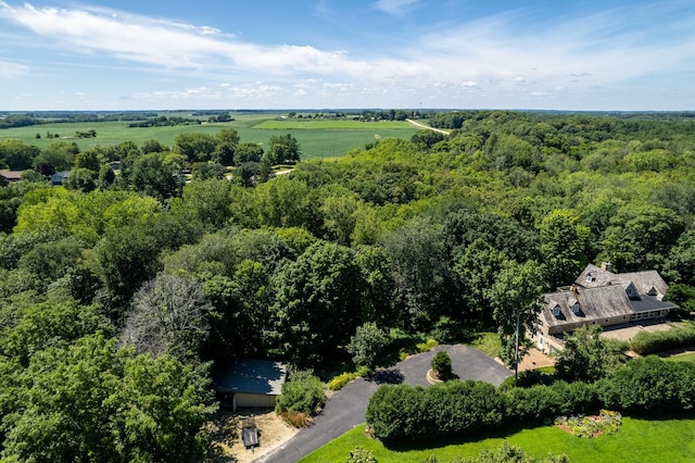 drone / aerial view featuring a wooded view