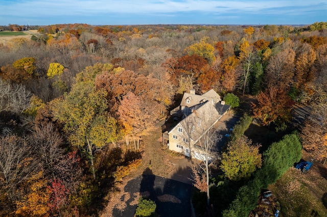 birds eye view of property with a view of trees