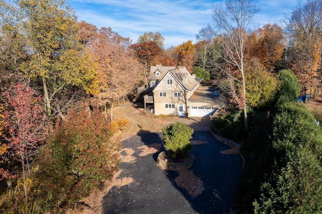 birds eye view of property featuring a view of trees