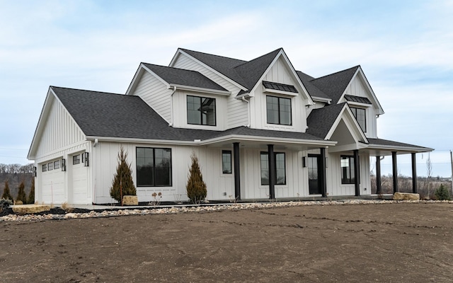 modern farmhouse with a garage and a porch