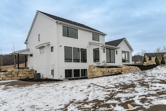 snow covered property featuring central air condition unit