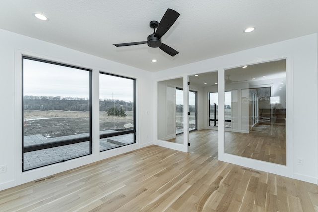 interior space with light hardwood / wood-style floors and ceiling fan