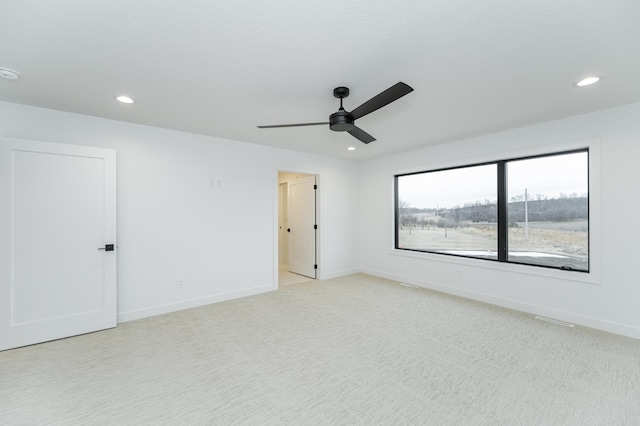 carpeted empty room featuring ceiling fan