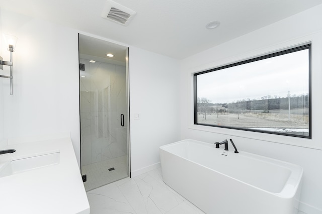 bathroom featuring shower with separate bathtub, a healthy amount of sunlight, and sink