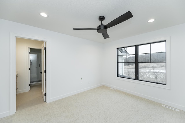 carpeted empty room with ceiling fan