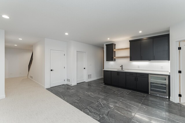 kitchen featuring beverage cooler and sink