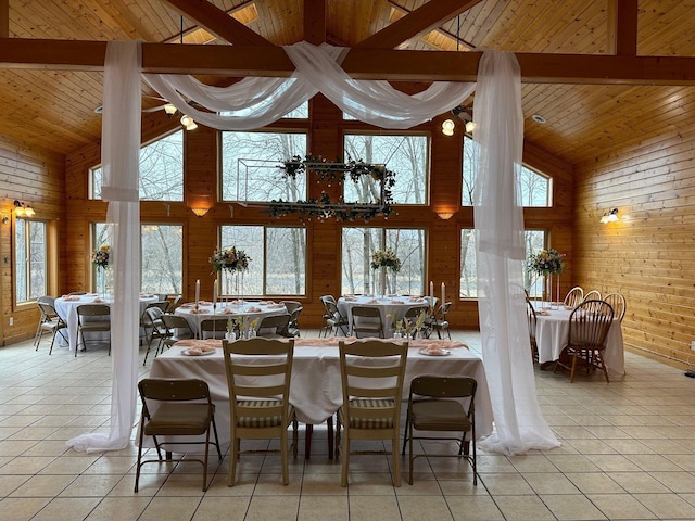 dining space with wood ceiling, high vaulted ceiling, and light tile patterned flooring