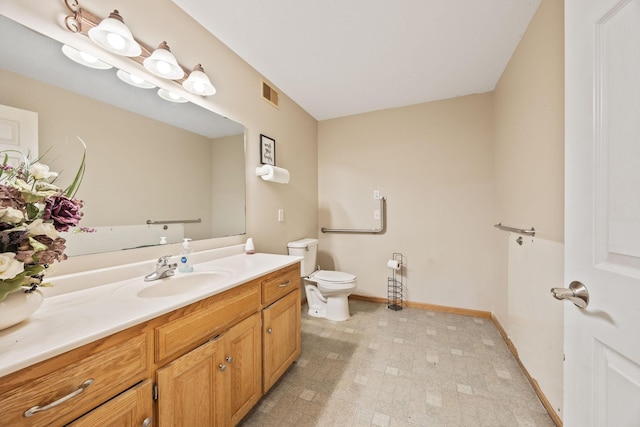 bathroom featuring vanity, tile patterned flooring, and toilet