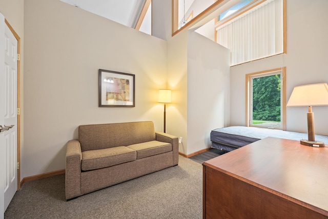 carpeted home office with high vaulted ceiling