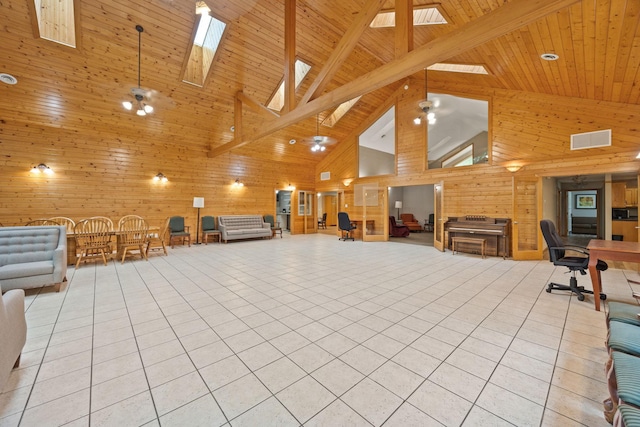 miscellaneous room featuring a skylight, high vaulted ceiling, wooden walls, light tile patterned flooring, and beamed ceiling