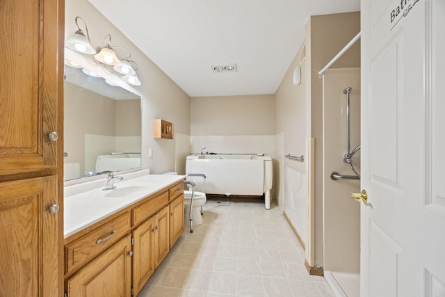 bathroom with tile patterned floors, vanity, and toilet