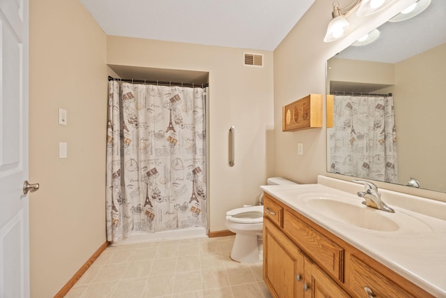 bathroom featuring tile patterned floors, vanity, and toilet