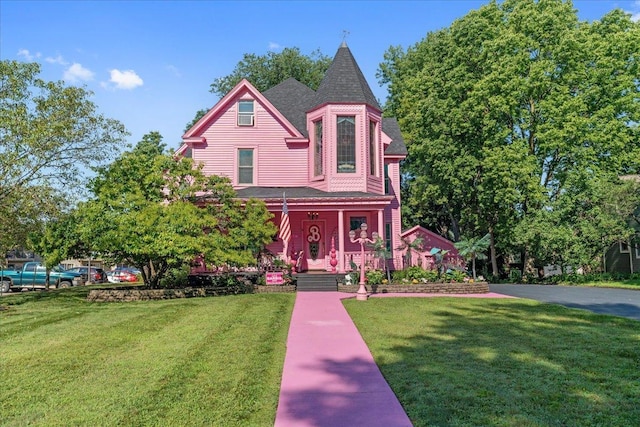 victorian-style house featuring a front yard