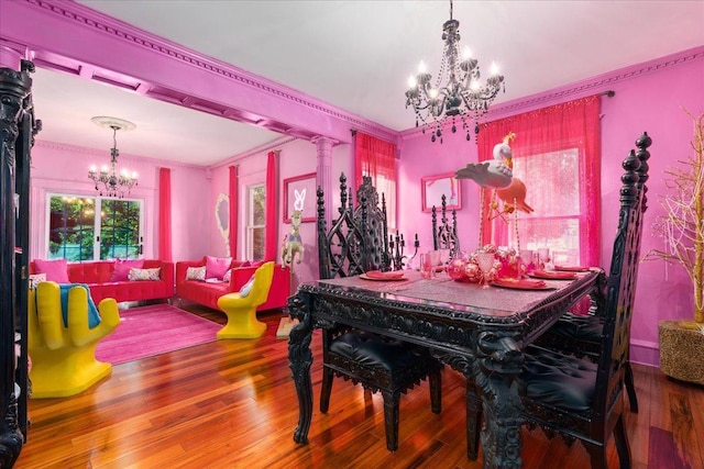 dining room with a chandelier, ornamental molding, and hardwood / wood-style flooring