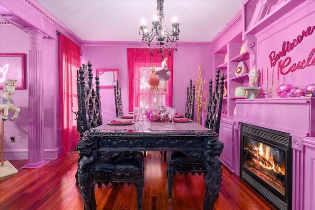 dining space with decorative columns, a notable chandelier, dark hardwood / wood-style flooring, and crown molding