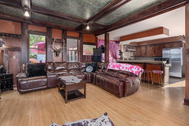 living room with coffered ceiling, beam ceiling, and light hardwood / wood-style floors