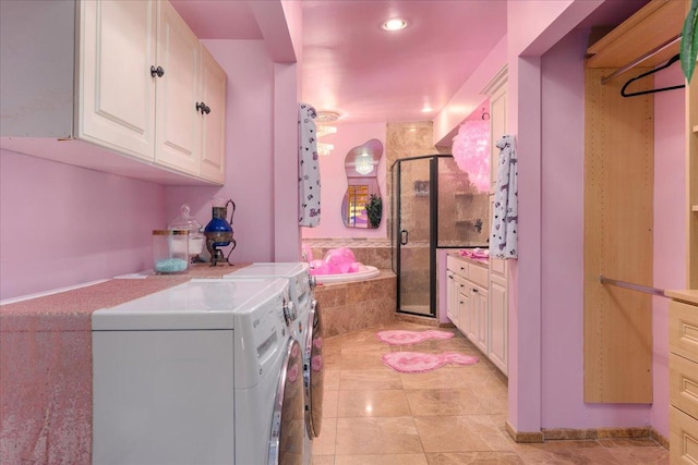 laundry area with light tile patterned floors and separate washer and dryer