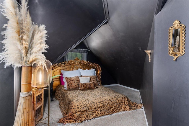 bedroom featuring lofted ceiling and carpet