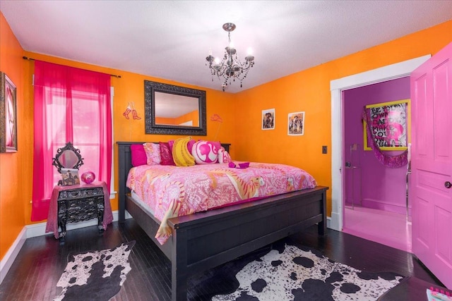 bedroom with a notable chandelier and dark hardwood / wood-style floors