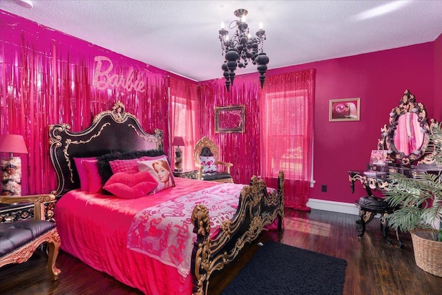 bedroom with hardwood / wood-style floors, a textured ceiling, and a chandelier