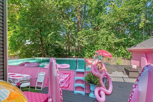 wooden terrace featuring a pool