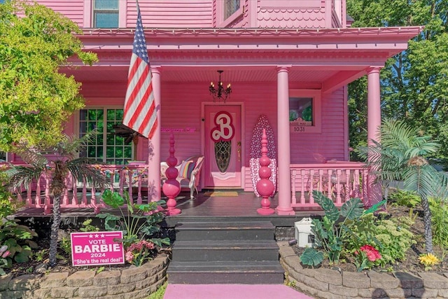 view of exterior entry with covered porch