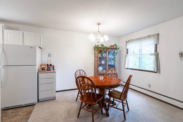 dining space with a chandelier, a textured ceiling, light colored carpet, and a baseboard heating unit