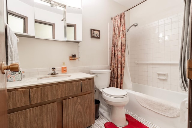 full bathroom with tile patterned flooring, shower / bath combination with curtain, toilet, and vanity