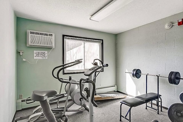 workout area with a textured ceiling and a wall mounted AC