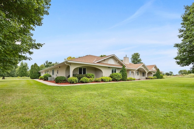 69531-1 213th St, Darwin, MN 55324 - view of front of house featuring a chimney, stucco siding, and a front lawn