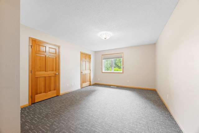 unfurnished bedroom with a textured ceiling and carpet