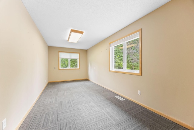 spare room featuring light colored carpet