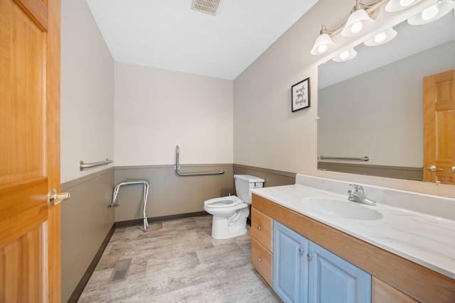 bathroom featuring toilet and vanity