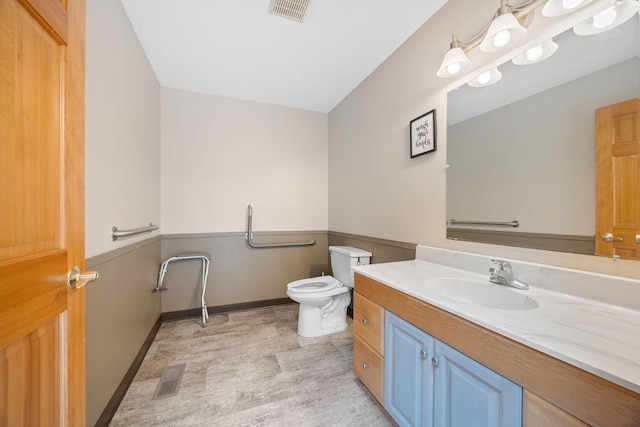 69531-1 213th St, Darwin, MN 55324 - bathroom featuring vanity, toilet, visible vents, and wood finished floors