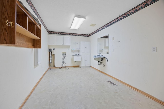 washroom featuring washer hookup and cabinets