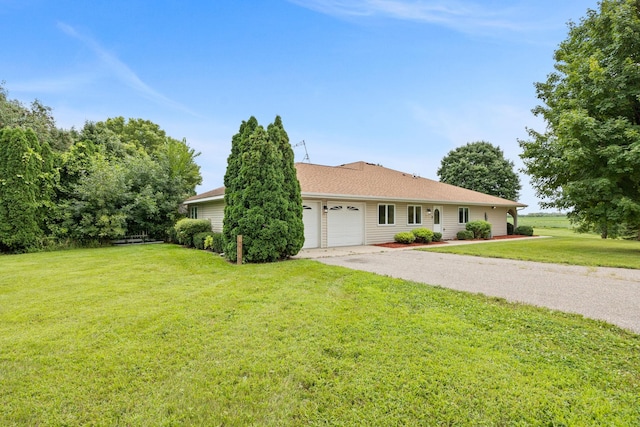 ranch-style house featuring a front lawn and a garage