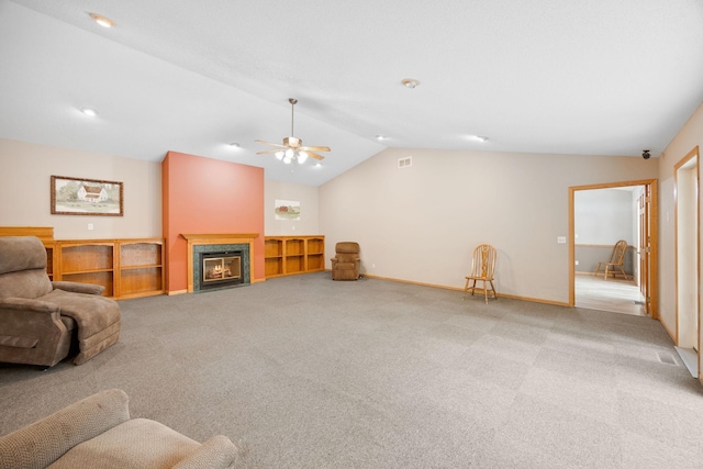 carpeted living room featuring ceiling fan and vaulted ceiling