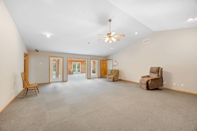 unfurnished room with ceiling fan, lofted ceiling, and light carpet