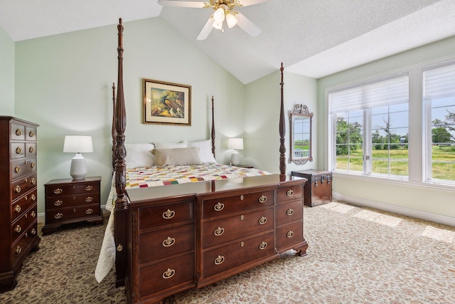 carpeted bedroom featuring lofted ceiling, ceiling fan, a textured ceiling, and baseboards