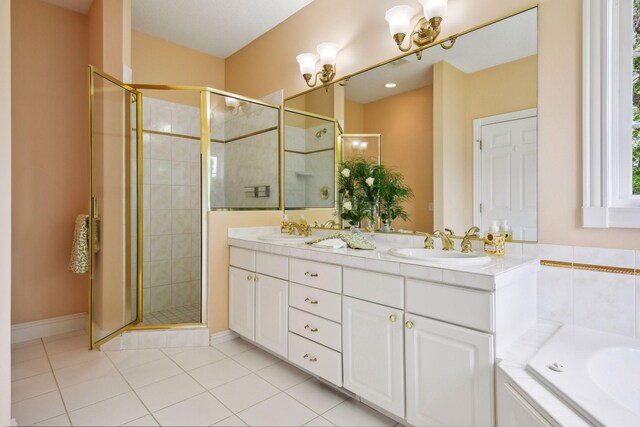 full bathroom with double vanity, a shower stall, a sink, and tile patterned floors