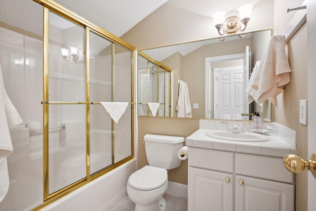 bathroom featuring toilet, tile patterned floors, combined bath / shower with glass door, vaulted ceiling, and vanity