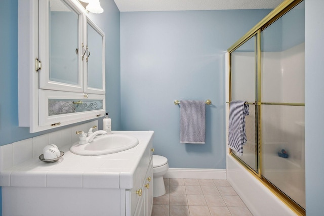 full bath with toilet, vanity, baseboards, combined bath / shower with glass door, and tile patterned floors