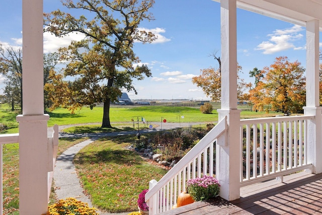 view of yard featuring covered porch and a rural view