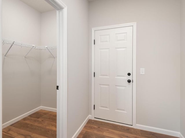 interior space featuring baseboards and wood finished floors