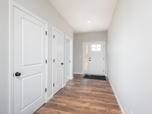 entryway with wood finished floors and baseboards