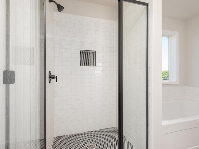 bathroom with shower with separate bathtub