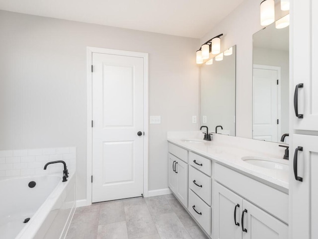 bathroom featuring vanity, a washtub, and tile patterned flooring